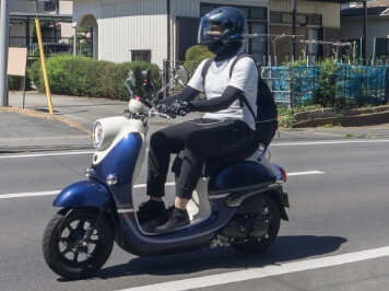 原付バイクに乗っている人の写真